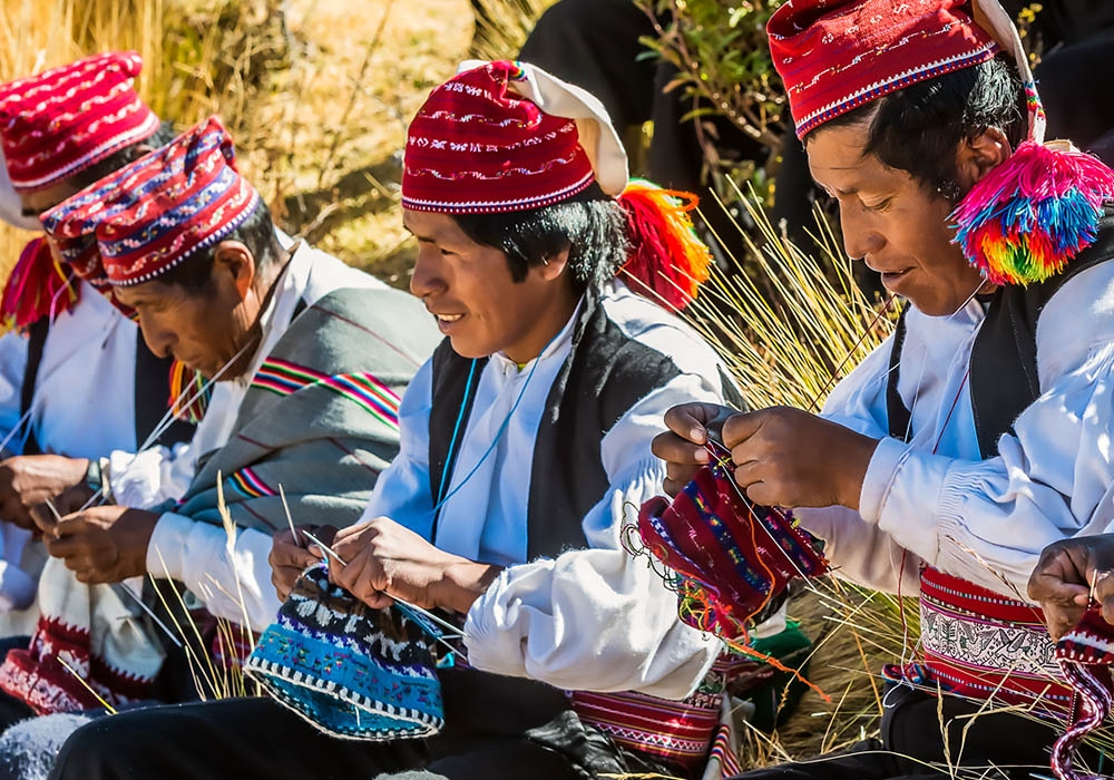 The traditional activity of a man in Taquile knitting his Chullos of wool