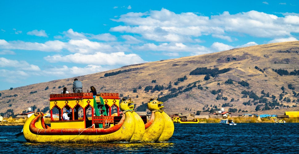 Journey from the UK to Lake Titicaca on your Peru luxury vacation. This stunning high-altitude lake nestled between Peru and Bolivia, is home to unique cultures and traditions of the indigenous communities that call the lake's shores home.