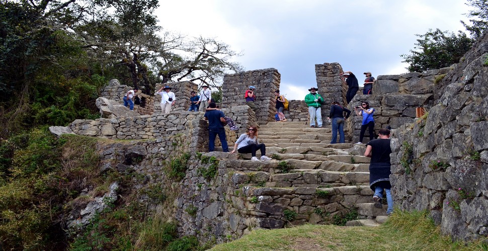 Hike to Inti Punku from the Machu Picchu site. It is a popular option for visitors who want to experience this iconic site from a different perspective on their Machu Picchu vacation packages. The hike takes about 1-2 hours round trip and offers stunning views of Machu Picchu.