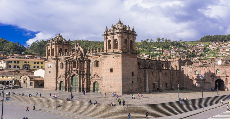 The steps of the Cusco Cathedral, overlooking the Plaza de Armas, are a notable spot in the Cusco city tour. These steps are not only to access the cathedral but also a gathering place for locals and tourists alike. Here, you'll find people sitting, chatting, and enjoying the vibrant atmosphere of the plaza.