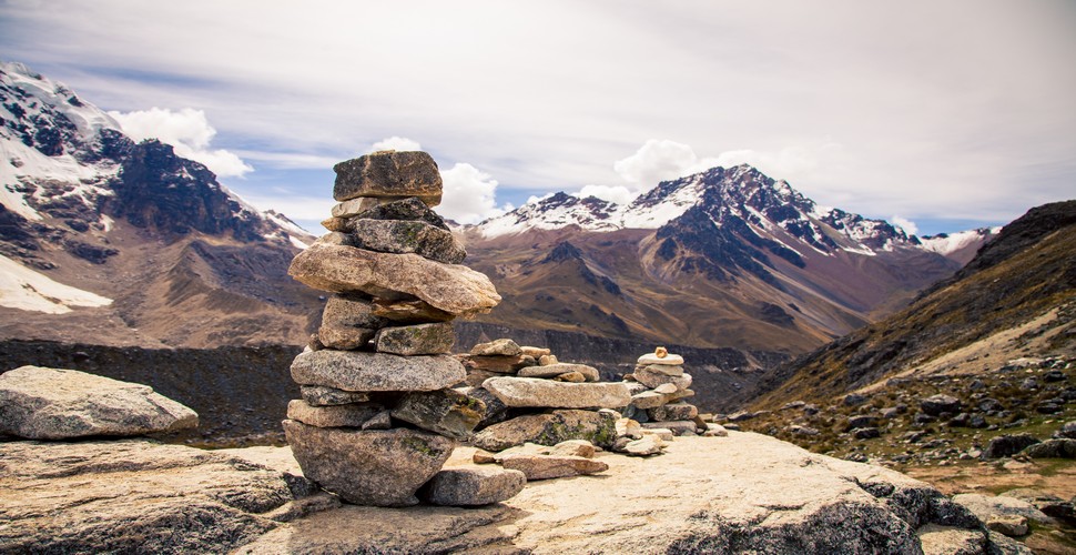 Along the stunning Ausangate high-altitude trek in the Peruvian Andes on Cusco adventure tours,  you'll encounter a rich tapestry of Andean culture, including the tradition of apachetas. Apachetas are a testament to the reverence the local people hold for the mountains and the natural world.